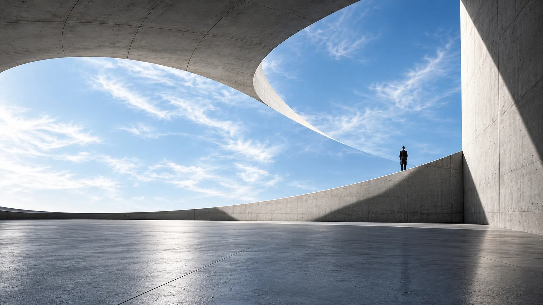 Geometric concrete forms opening toward blue sky